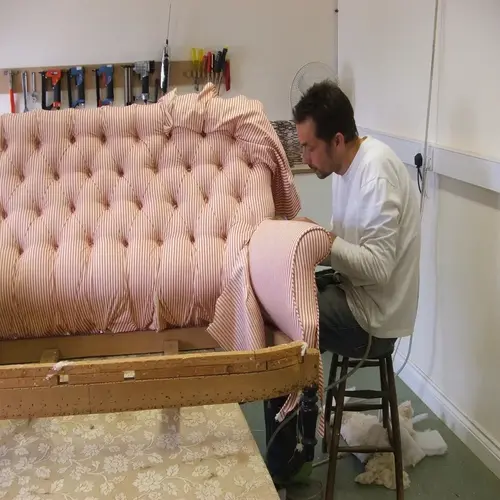 A man repair sofa in Dubai