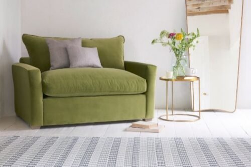 Green single-seater sofa with decor